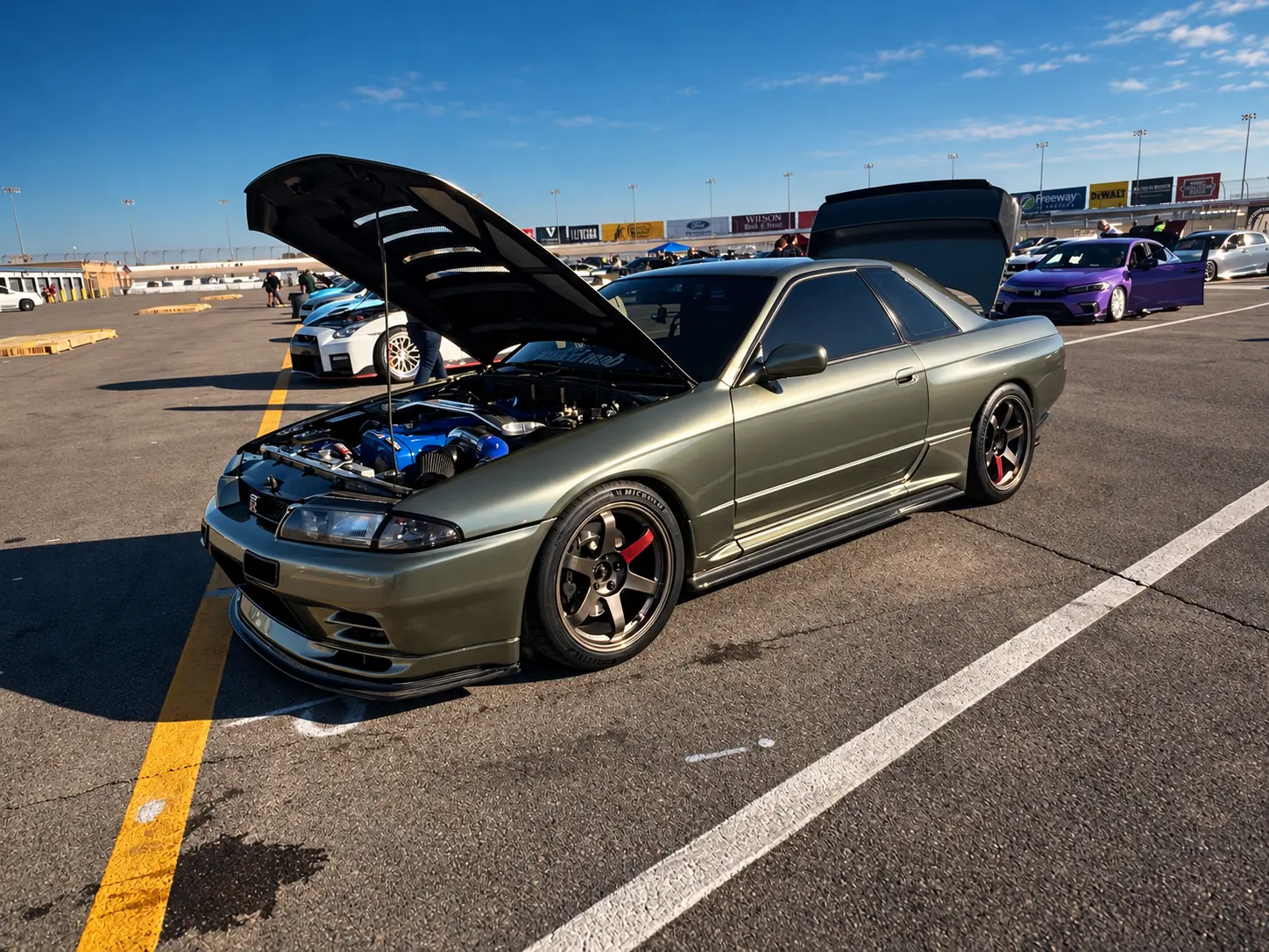 Gray Nissan Skyline with its engine bay on display at ImportAlliance Nashville Fall 2026